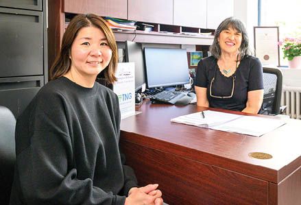 smiling woman sitting with case worker
