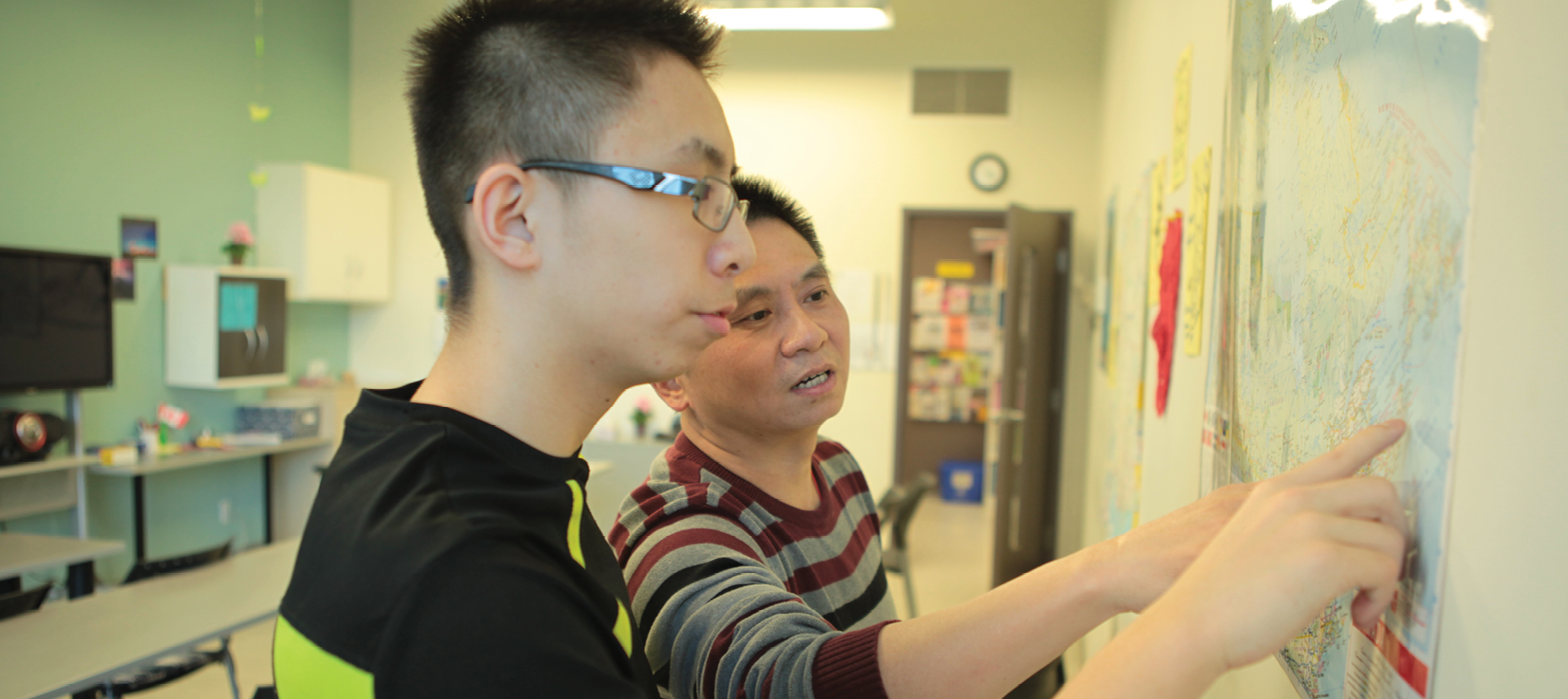 youth pointing at map in North York Newcomer Centre