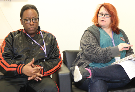 man and woman sitting and talking