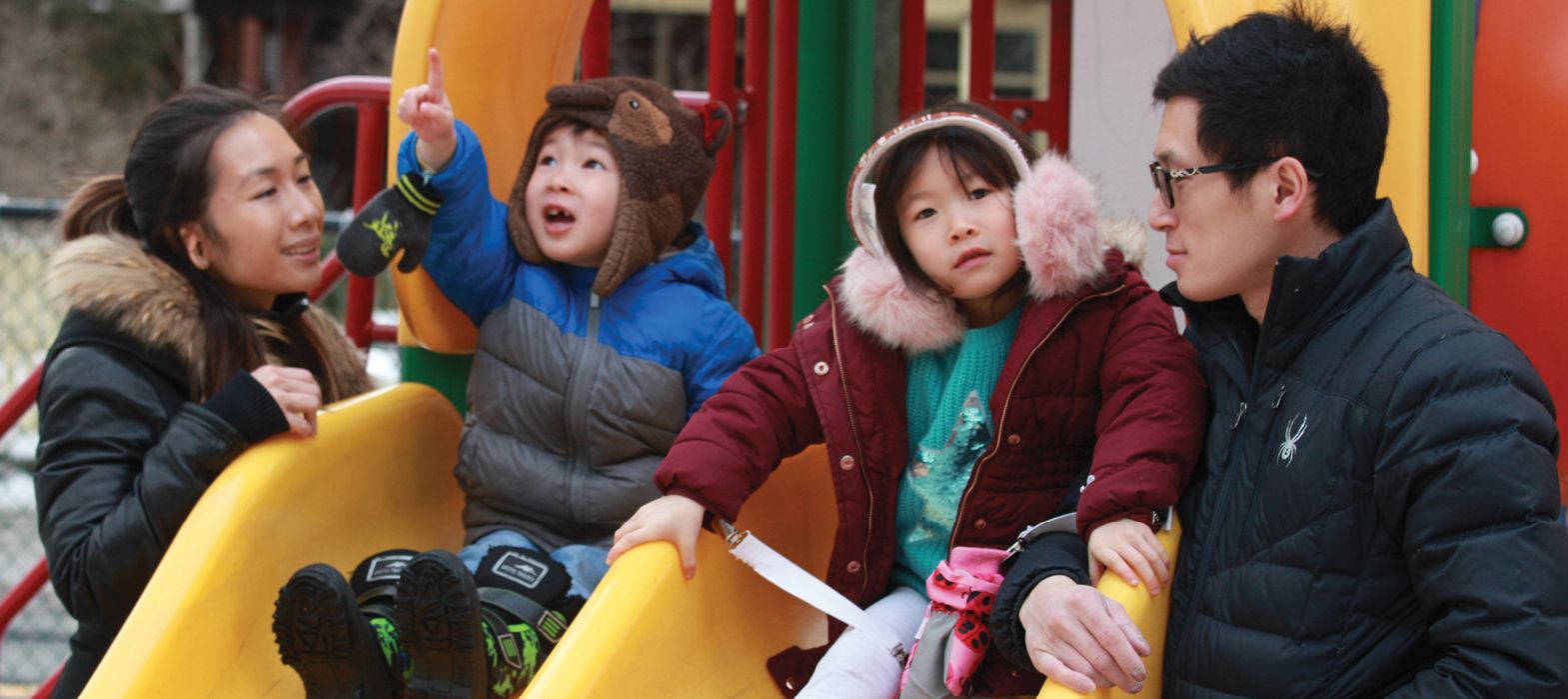 Mother and children playing at the Bellevue Ave. Child Care Centre playground