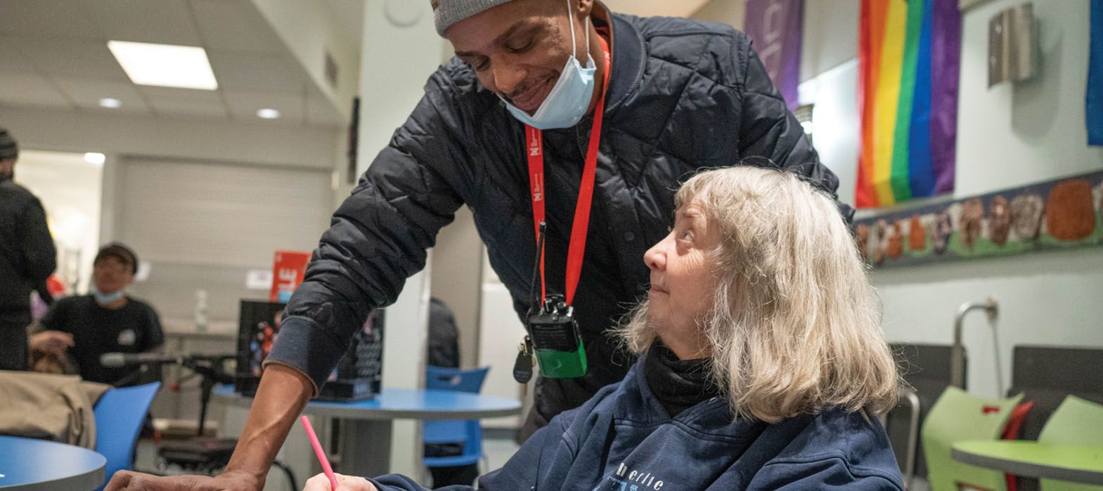 staff talking to smiling woman
