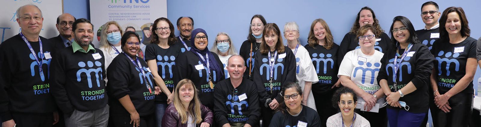 group of staff wearing black TNG t-shirtd