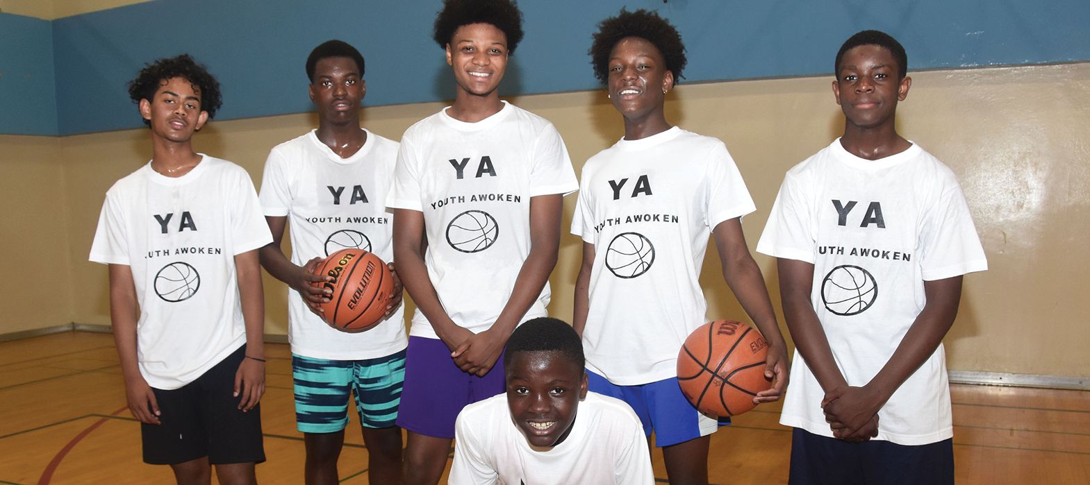 young men in Youth Awoken t-shirts posing before playing basketball
