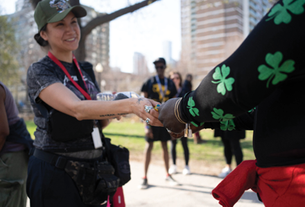 woman in park handing out supplies to encampment residents