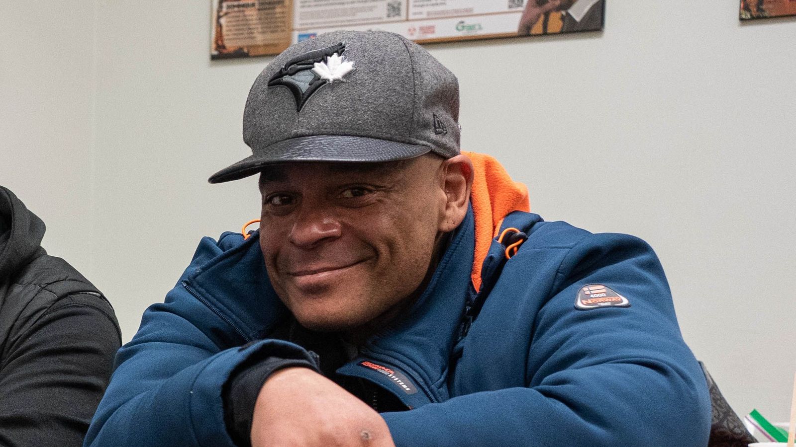 smiling man sitting at a table in a waiting room
