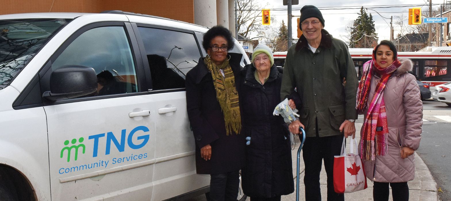 volunteer driver standing with seniors in front of TNG vehicle