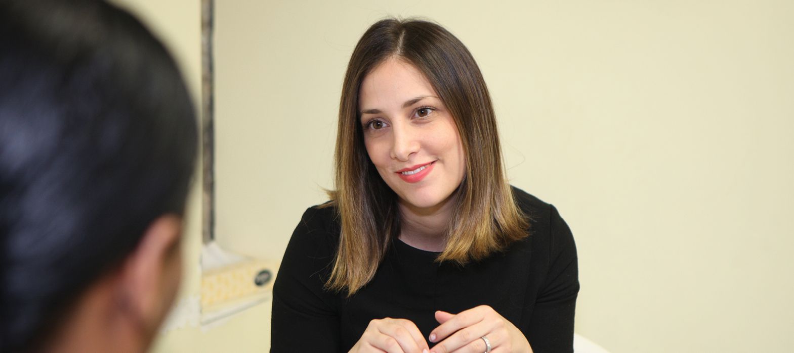 smiling young woman talking to a youth