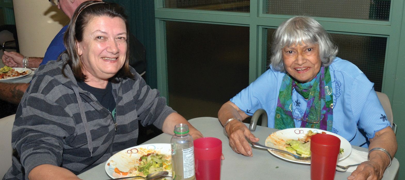 two eldery women eating food