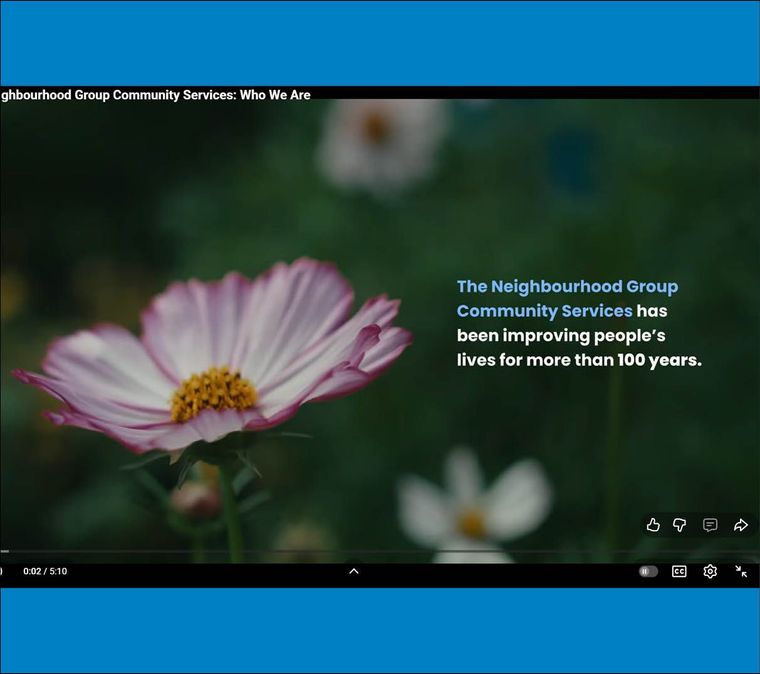 screen capture of video showing a flower and the words "The Neighbourhood Group Community Services has been improving people's lives for more than 100 years."