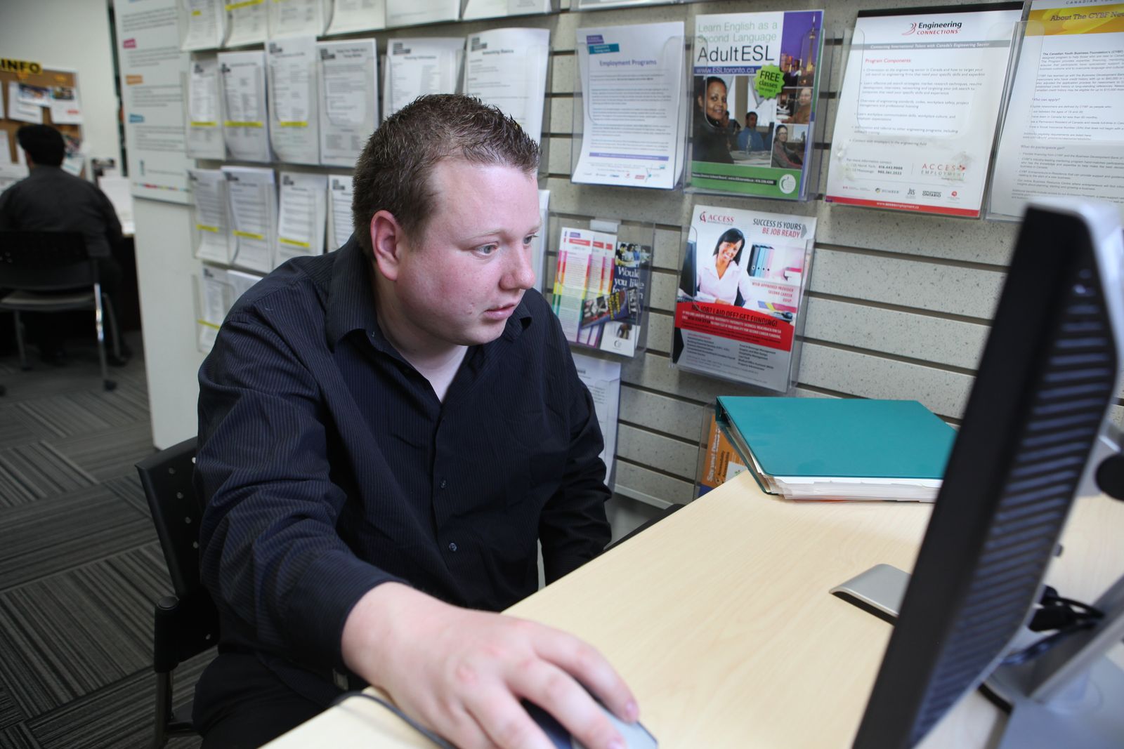 young man sitting at computer
