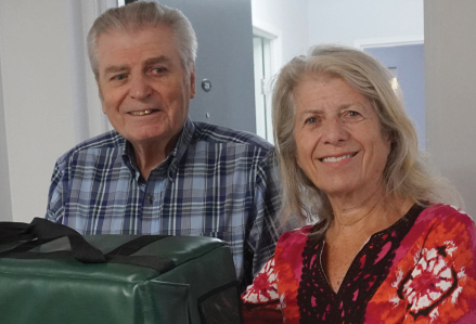 volunteer delivering a meal to a senior