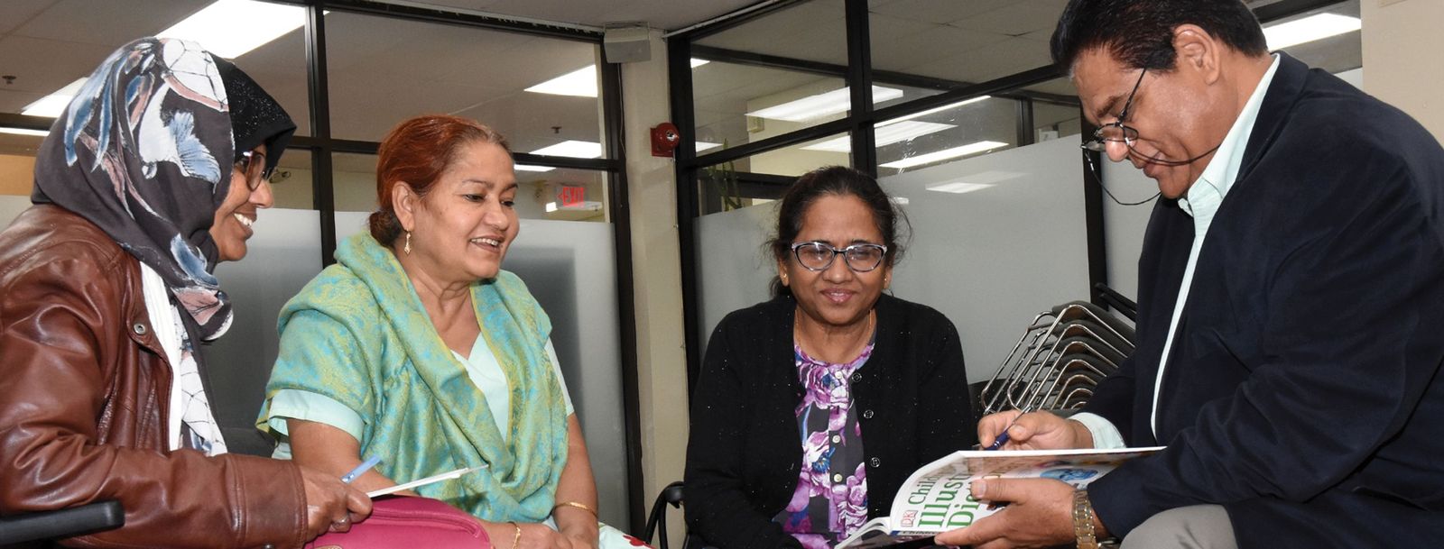 women and man reading and talking