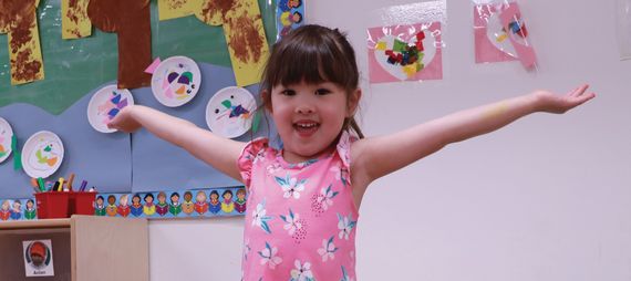 young girl spreading her arms and smiling
