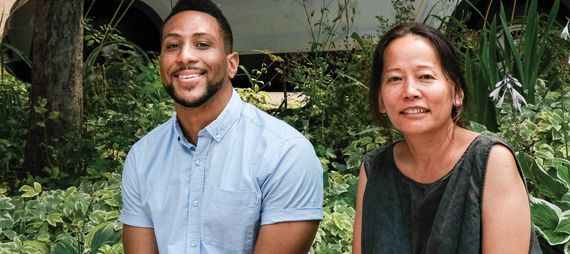 man and woman sitting in park