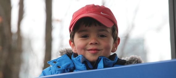 smiling boy in a baseball cap